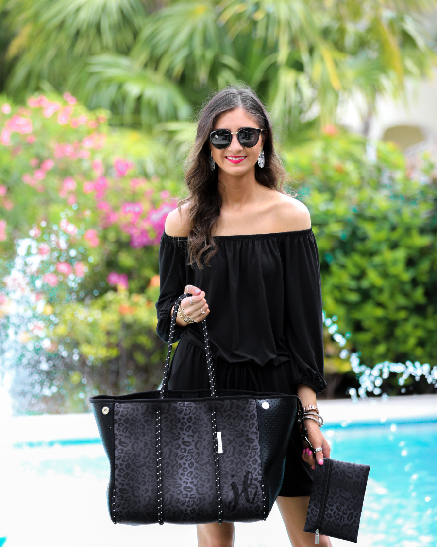 ultra-lightweight tote made of neoprene with a removable hard bottom liner, paracord shoulder straps, removable matching zippered pouch, magnetic side snap closures in silver hardware, and black interior (tote and pouch) on a black on black leopard print pattern