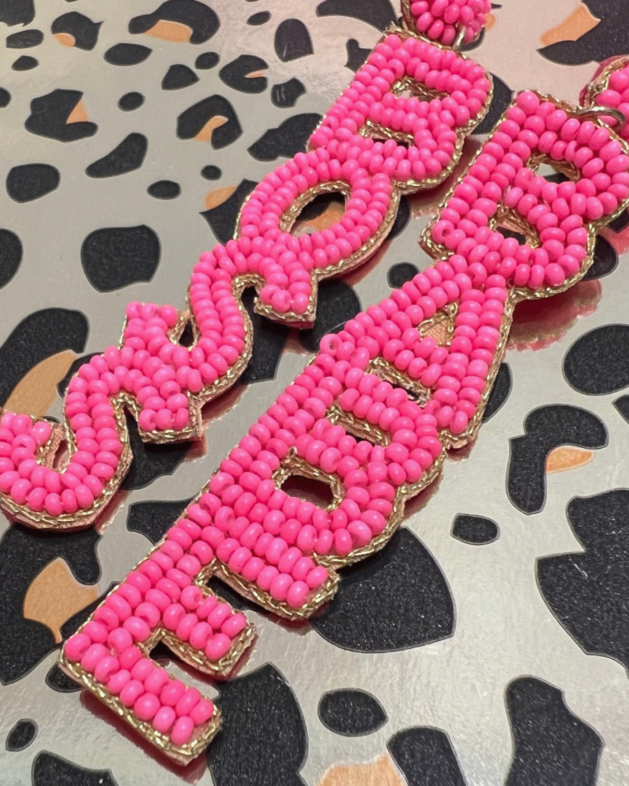 ultra-lightweight hot pink outlined in gold word drop statement earrings highlighting the phrase BOSS (right) and BABE (left) with a post stud, felt backing, comfort replacement backs, and gold-tone plastic disk stopper