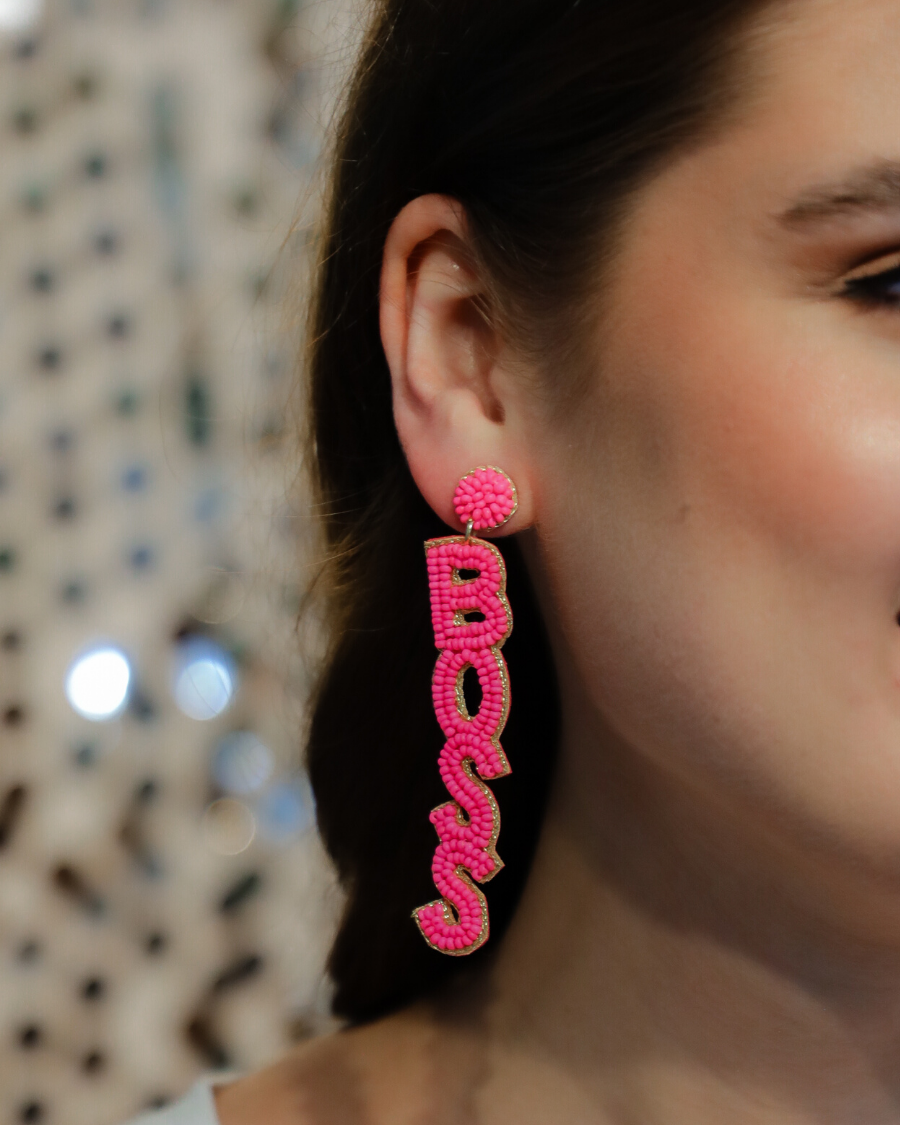 ultra-lightweight hot pink outlined in gold word drop statement earrings highlighting the phrase BOSS (right) and BABE (left) with a post stud, felt backing, comfort replacement backs, and gold-tone plastic disk stopper