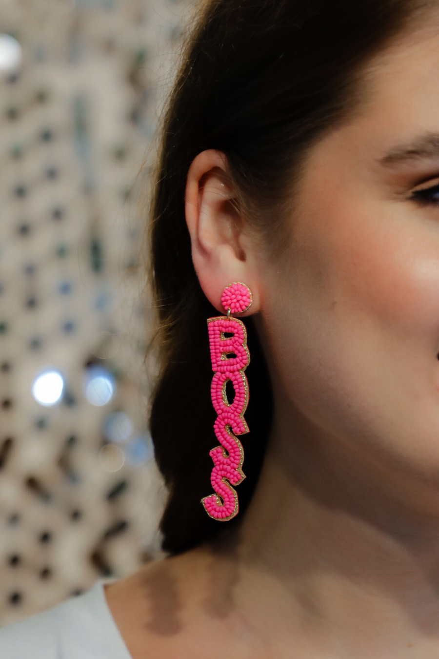 ultra-lightweight hot pink outlined in gold word drop statement earrings highlighting the phrase BOSS (right) and BABE (left) with a post stud, felt backing, comfort replacement backs, and gold-tone plastic disk stopper