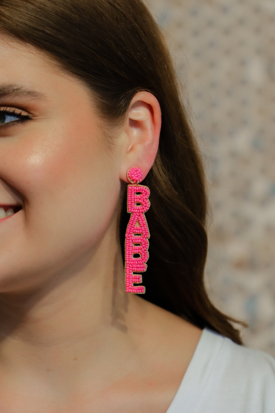 ultra-lightweight hot pink outlined in gold word drop statement earrings highlighting the phrase BOSS (right) and BABE (left) with a post stud, felt backing, comfort replacement backs, and gold-tone plastic disk stopper