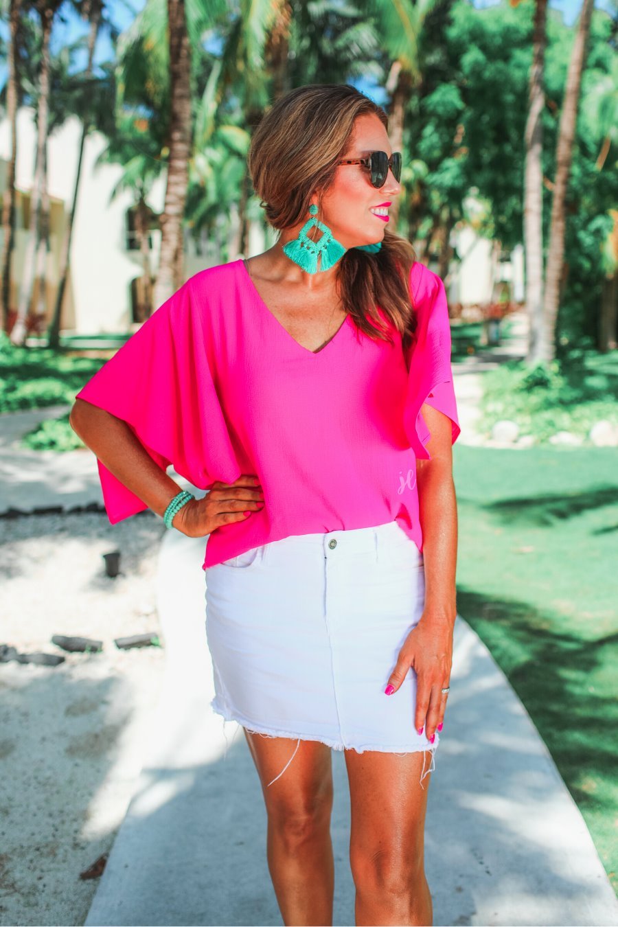 a pink v-neck blouses crafted from lightweight textured fabric with asymmetrical half-flutter sleeves, front lining, and a relaxed fit