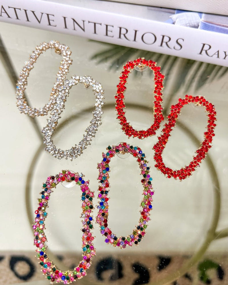 gold cubic zirconia earrings secured with a push backing in a long oval shape in crystal, multi, and red