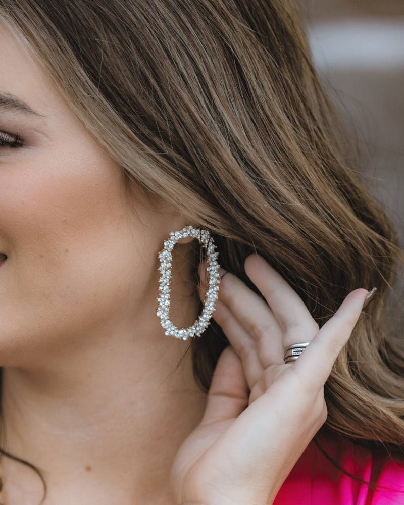 gold cubic zirconia earrings secured with a push backing in a long oval shape in crystal