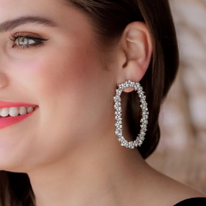 gold cubic zirconia earrings secured with a push backing in a long oval shape in crystal
