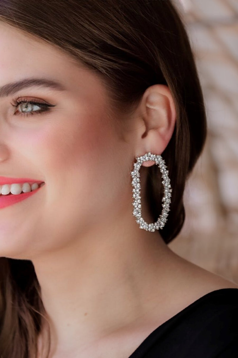 gold cubic zirconia earrings secured with a push backing in a long oval shape in crystal