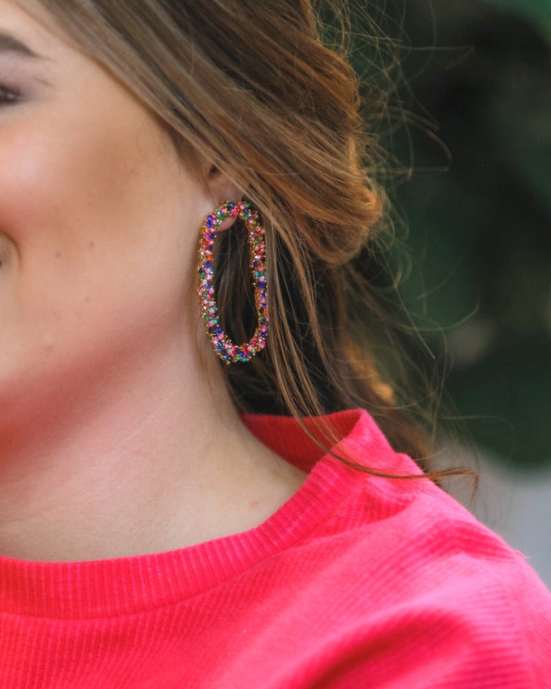 gold cubic zirconia earrings secured with a push backing in a long oval shape in multi