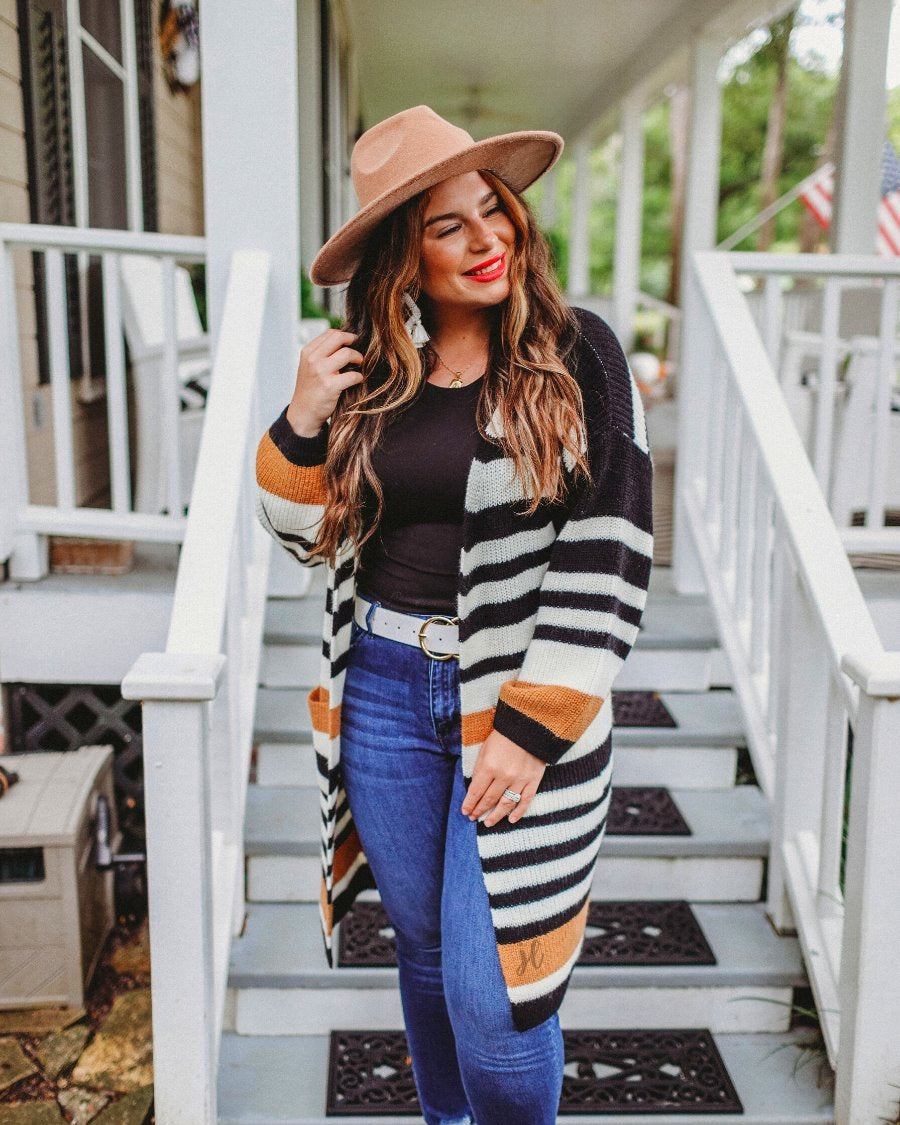 long-sleeve open front relaxed fit cardigan crafted from ultra soft, luxe knit with pockets on a black, caramel, and ivory stripe fabric