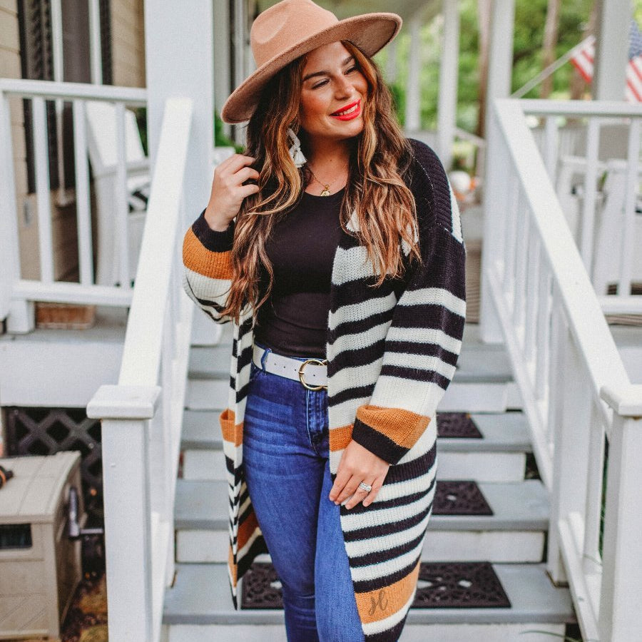 long-sleeve open front relaxed fit cardigan crafted from ultra soft, luxe knit with pockets on a black, caramel, and ivory stripe fabric