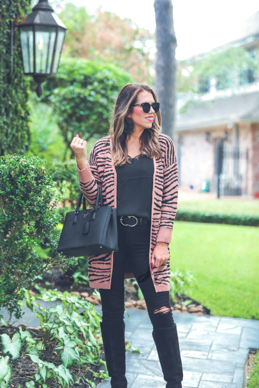 long-sleeve open front cardigan crafted from super soft material with bold tiger stripes, pockets, and an oversized fit on a brown base