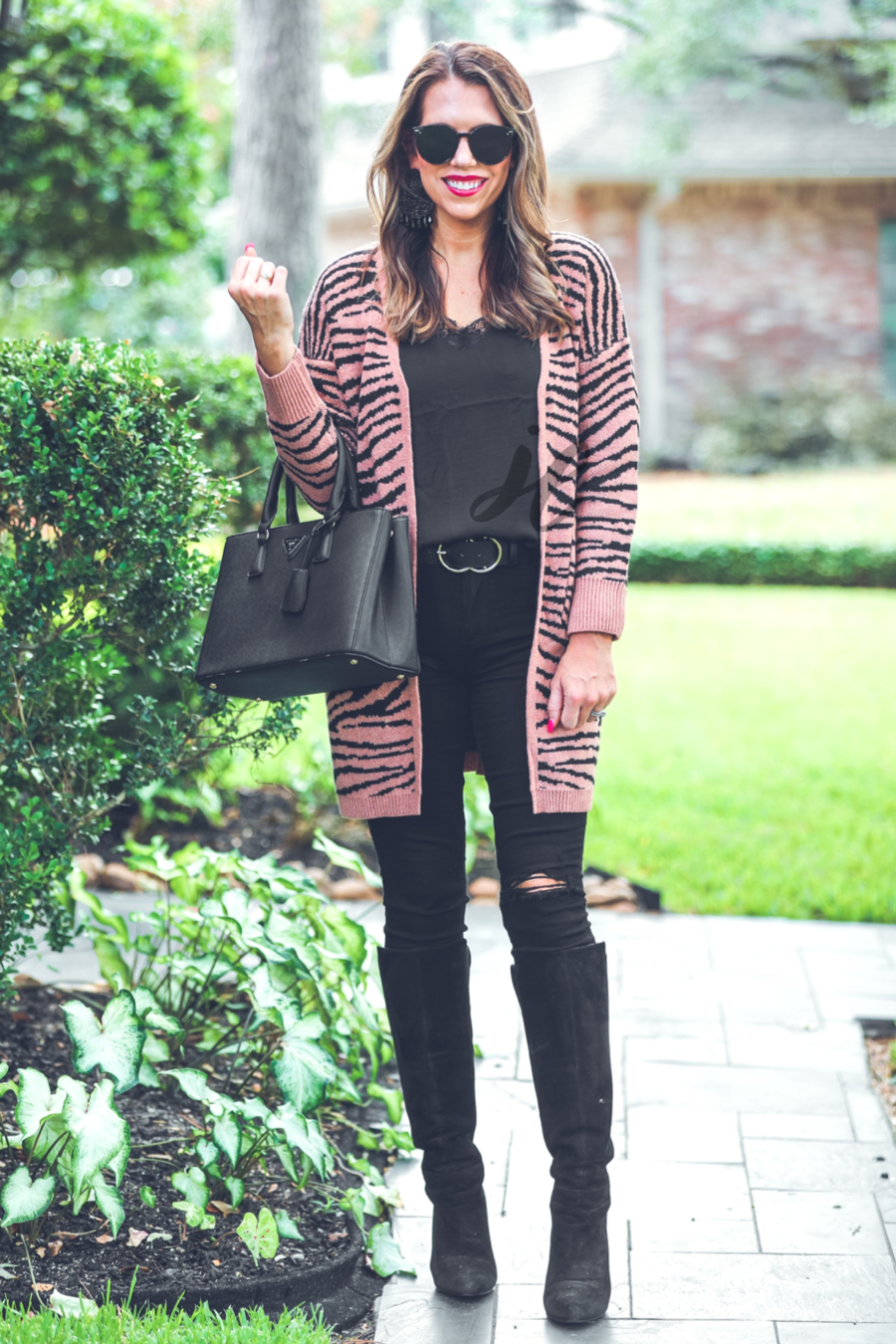 long-sleeve open front cardigan crafted from super soft material with bold tiger stripes, pockets, and an oversized fit on a brown base