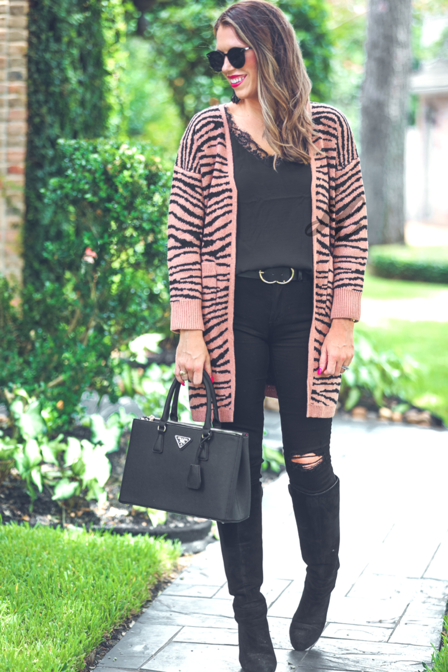 long-sleeve open front cardigan crafted from super soft material with bold tiger stripes, pockets, and an oversized fit on a brown base