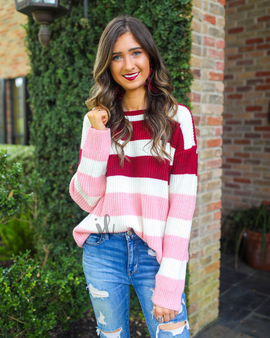 long sleeve sweater made of soft knitted material with colorful stripes in shades of pink in reverse ombré