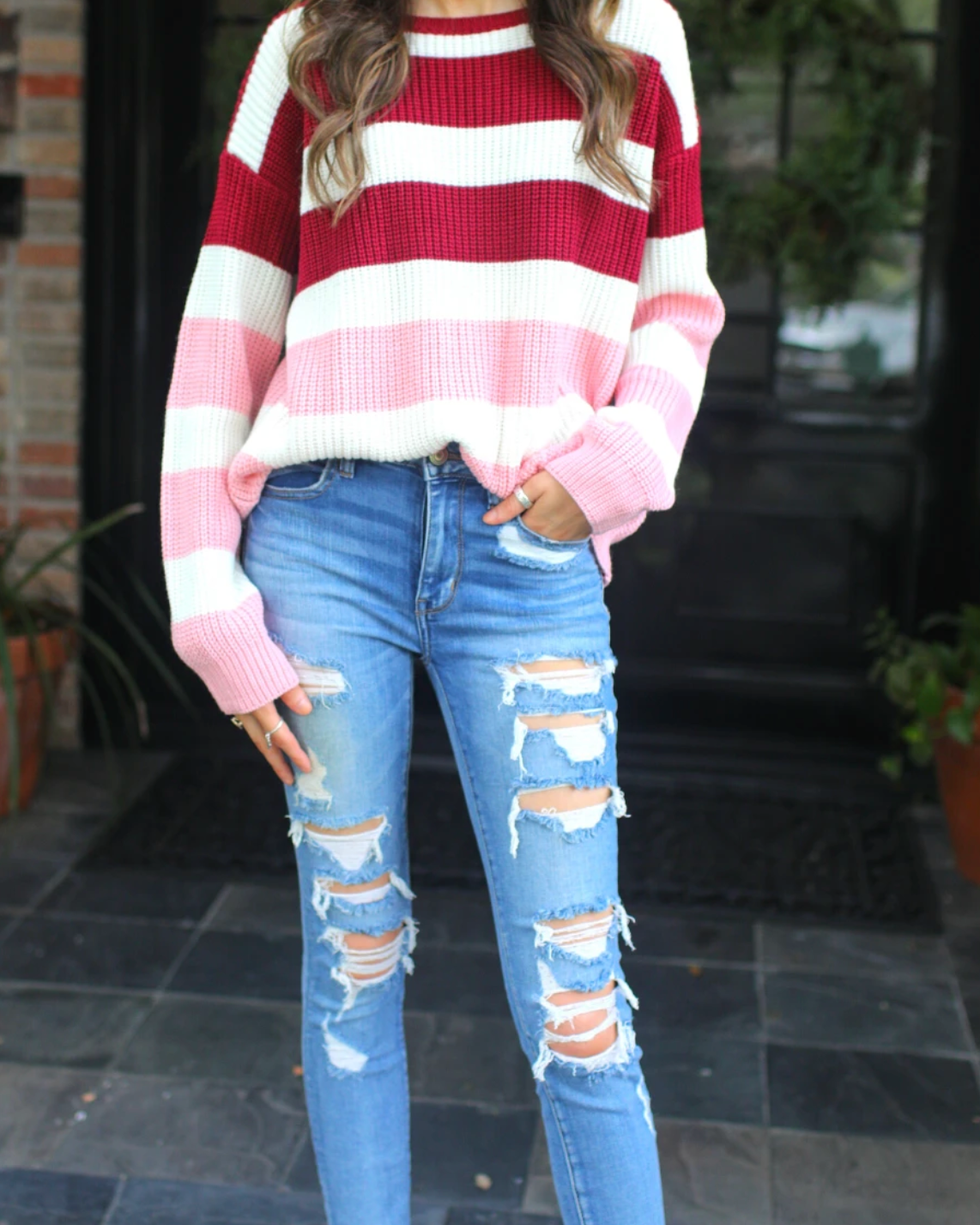 long sleeve sweater made of soft knitted material with colorful stripes in shades of pink in reverse ombré