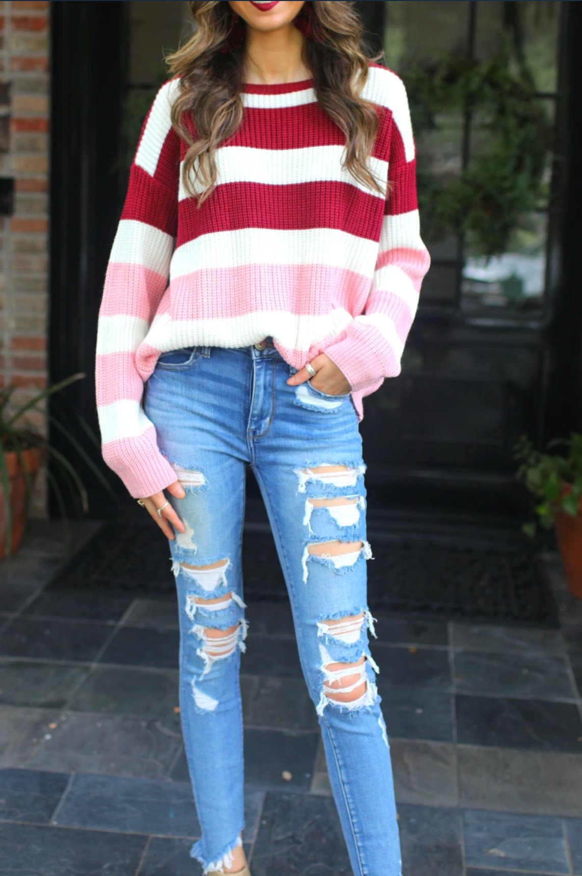 long sleeve sweater made of soft knitted material with colorful stripes in shades of pink in reverse ombré