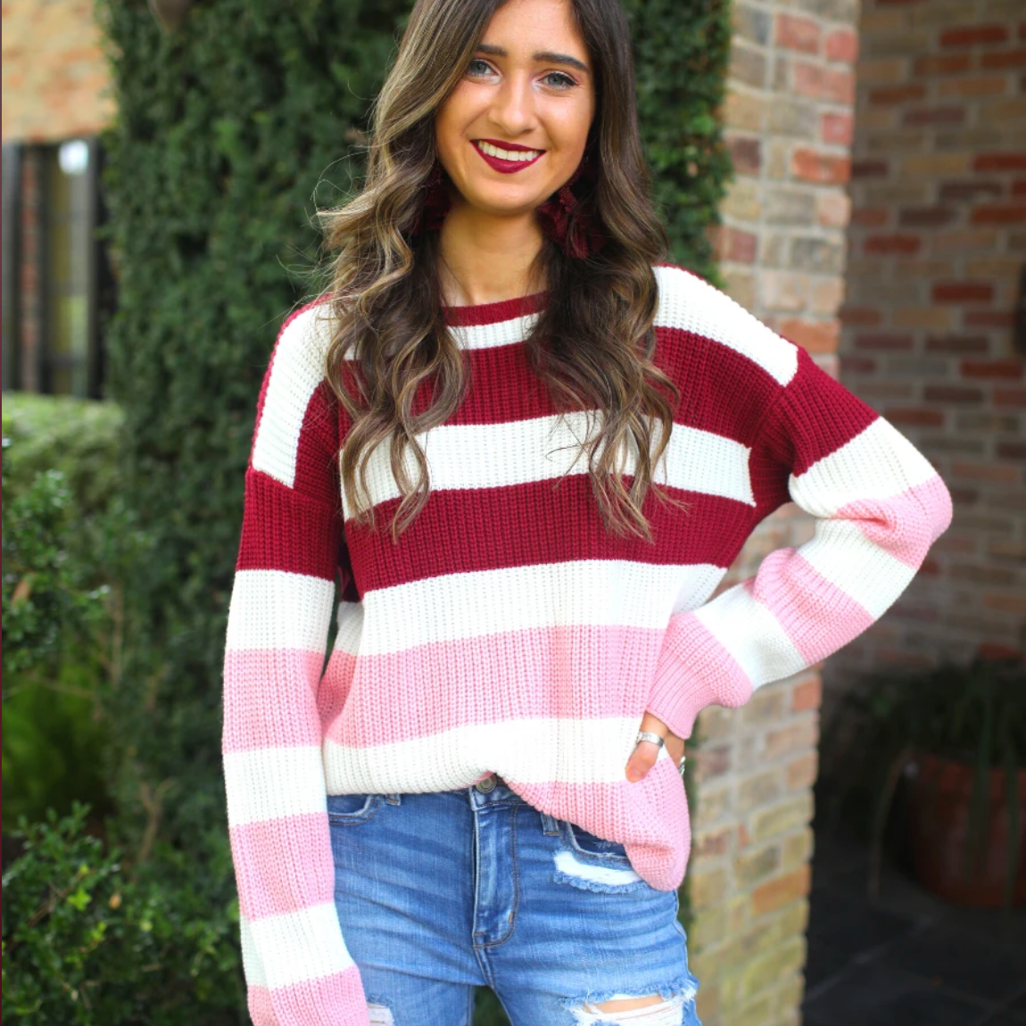long sleeve sweater made of soft knitted material with colorful stripes in shades of pink in reverse ombré