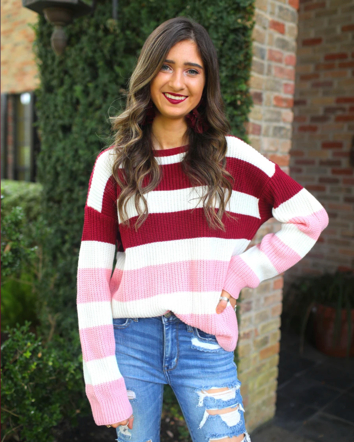 long sleeve sweater made of soft knitted material with colorful stripes in shades of pink in reverse ombré