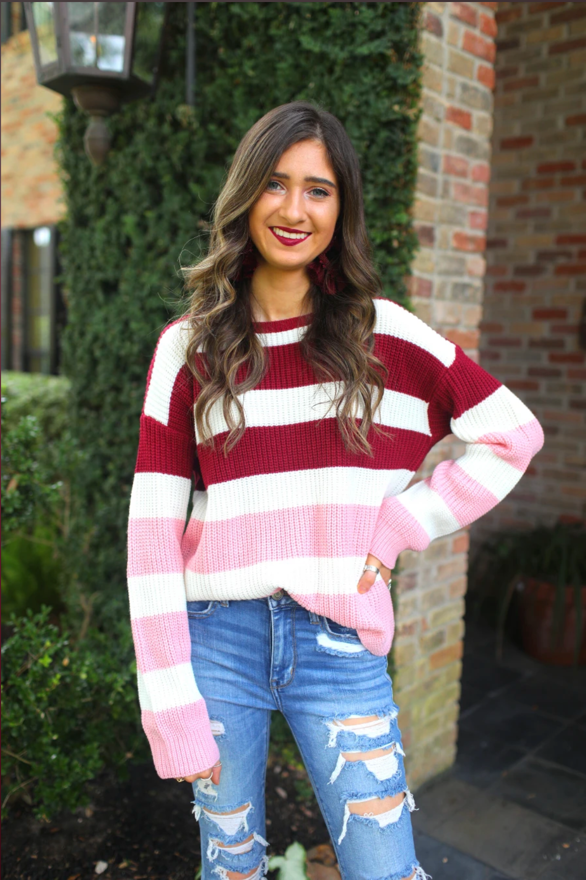 long sleeve sweater made of soft knitted material with colorful stripes in shades of pink in reverse ombré