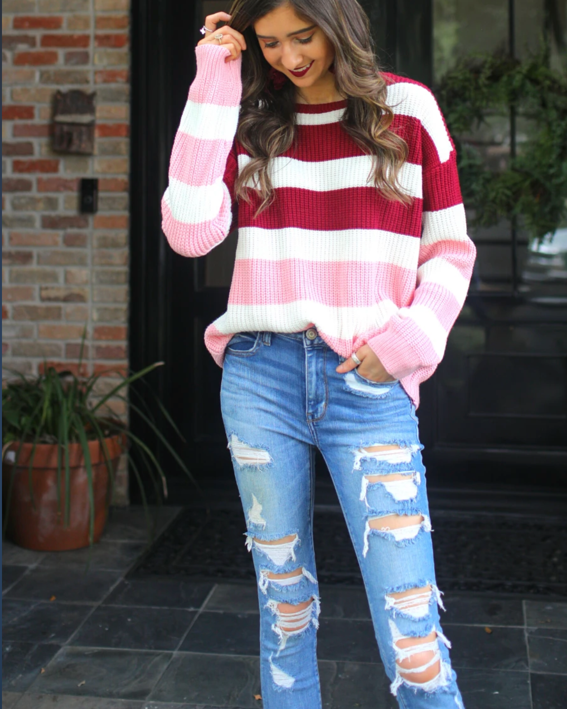 long sleeve sweater made of soft knitted material with colorful stripes in shades of pink in reverse ombré