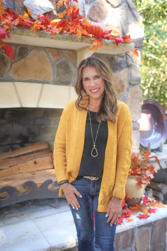 super soft and cozy cable knit fabric with an open front and relaxed fit in mustard