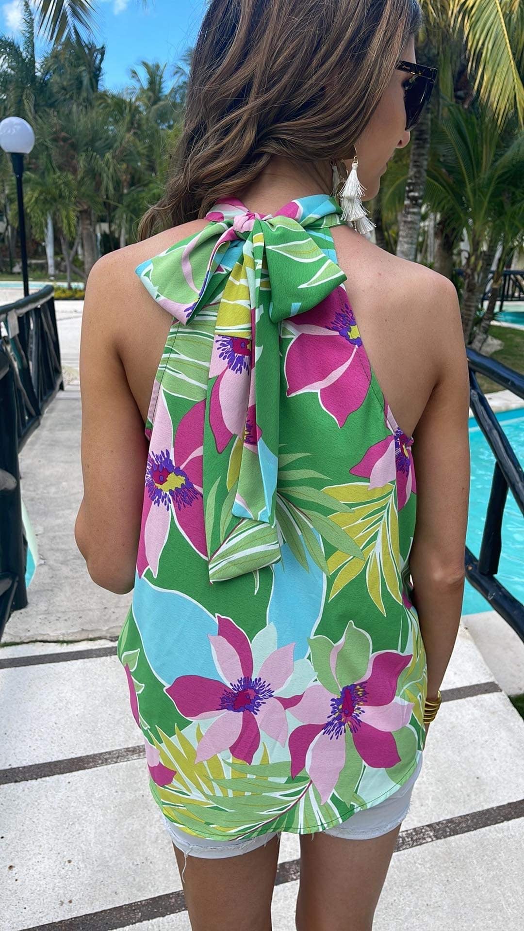 a bold green tropical floral halter with an adjustable tie-back neckline, airy draped silhouette, and lightweight woven fabric with no stretch