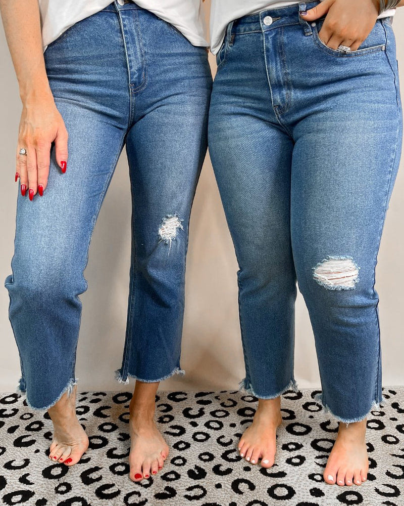 mid-rise distressed mom jeans with a raw hem, zip button-up fly, pockets, and some great stretch