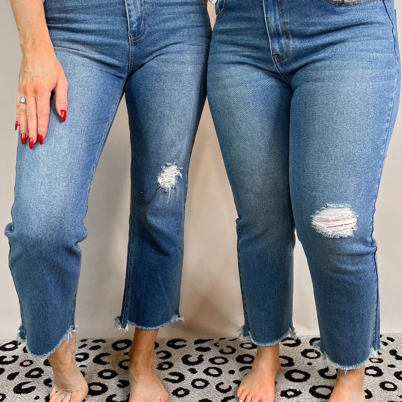 mid-rise distressed mom jeans with a raw hem, zip button-up fly, pockets, and some great stretch