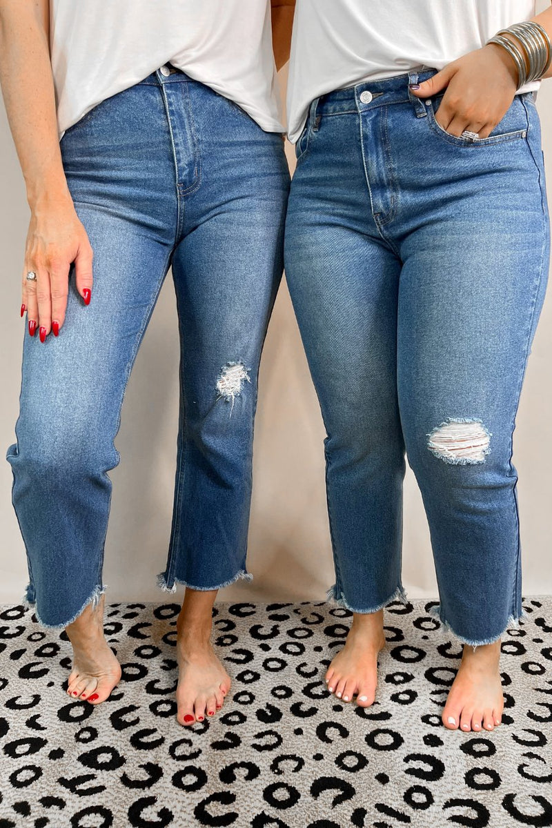 mid-rise distressed mom jeans with a raw hem, zip button-up fly, pockets, and some great stretch