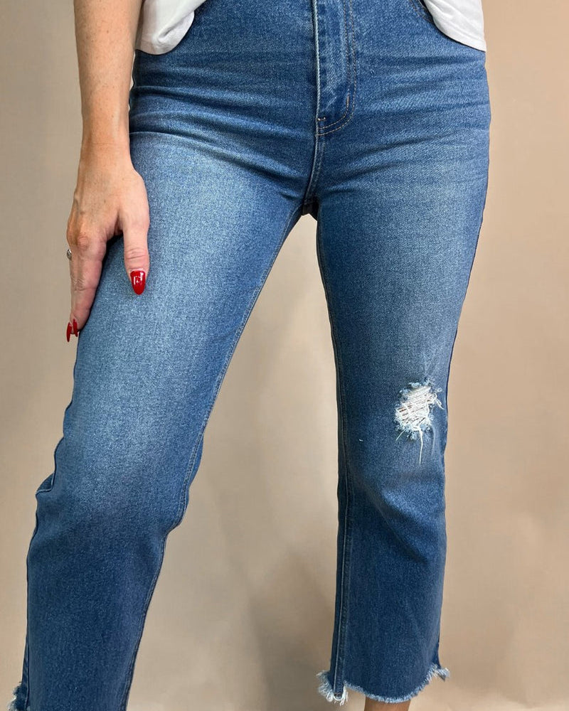 mid-rise distressed mom jeans with a raw hem, zip button-up fly, pockets, and some great stretch