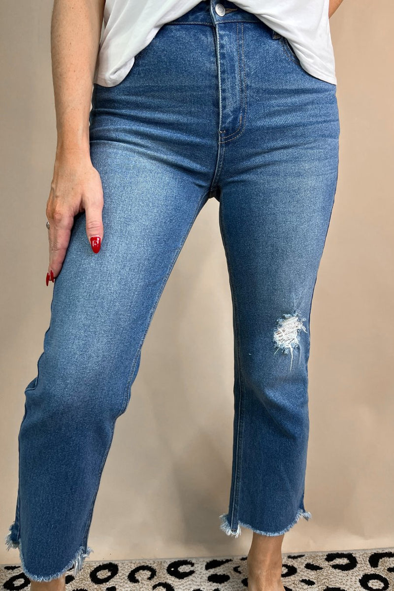 mid-rise distressed mom jeans with a raw hem, zip button-up fly, pockets, and some great stretch