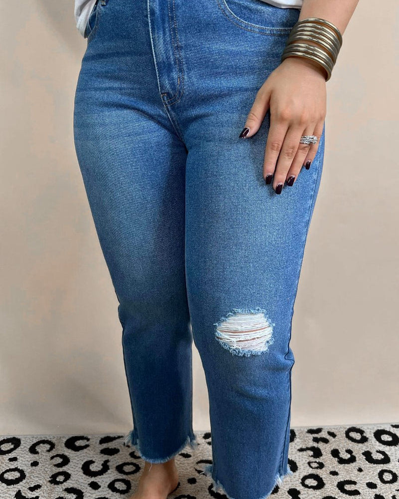 mid-rise distressed mom jeans with a raw hem, zip button-up fly, pockets, and some great stretch