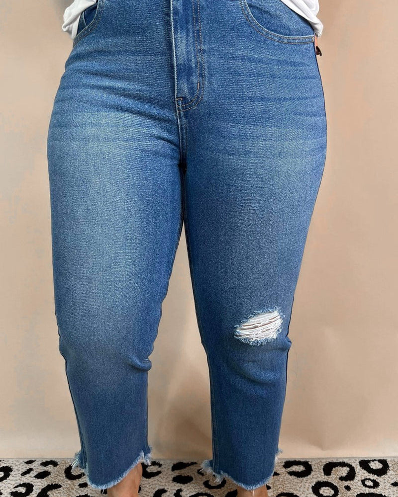 mid-rise distressed mom jeans with a raw hem, zip button-up fly, pockets, and some great stretch