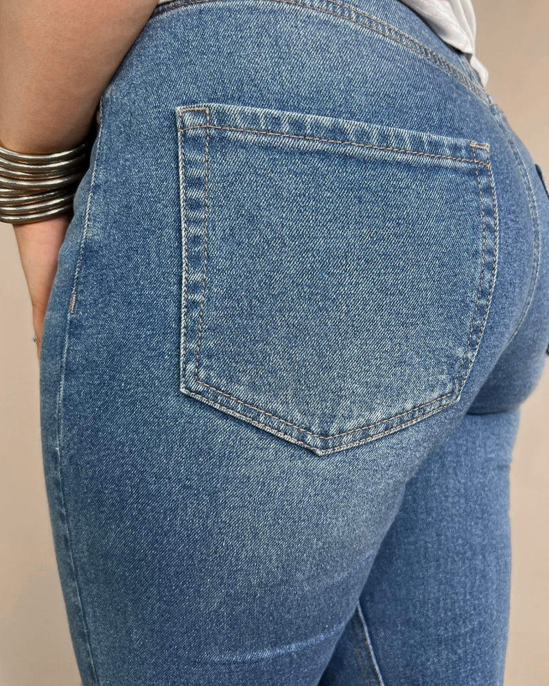 mid-rise distressed mom jeans with a raw hem, zip button-up fly, pockets, and some great stretch