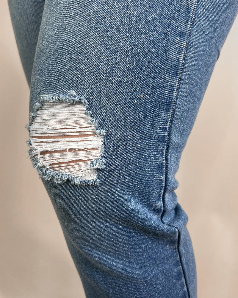 mid-rise distressed mom jeans with a raw hem, zip button-up fly, pockets, and some great stretch