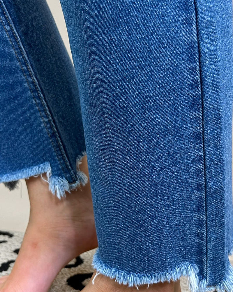 mid-rise distressed mom jeans with a raw hem, zip button-up fly, pockets, and some great stretch