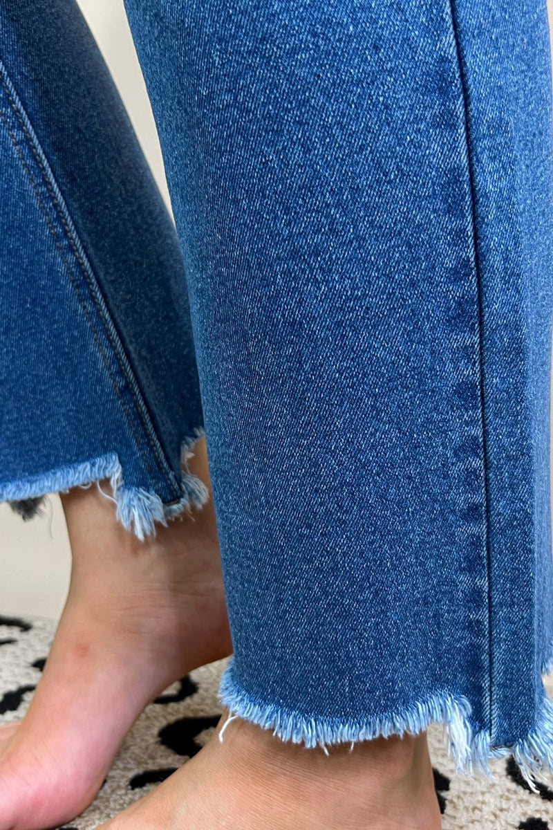 mid-rise distressed mom jeans with a raw hem, zip button-up fly, pockets, and some great stretch