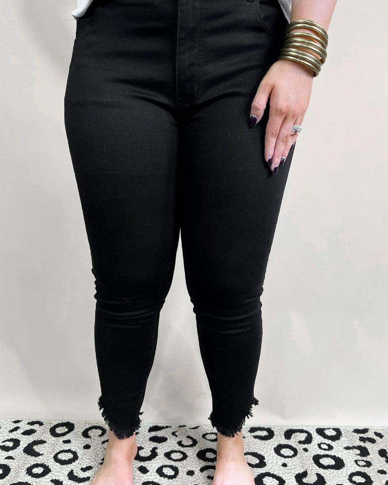 solid black mid-rise jeans with a distressed hem, zip button-up fly, pockets, and some great stretch