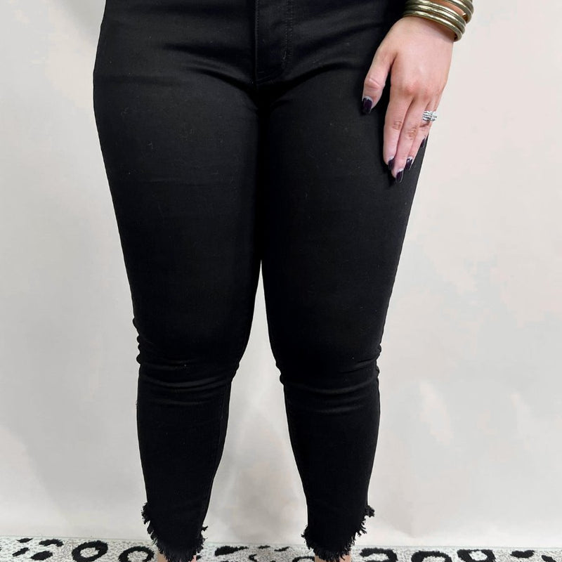 solid black mid-rise jeans with a distressed hem, zip button-up fly, pockets, and some great stretch