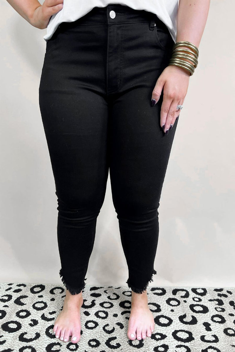 solid black mid-rise jeans with a distressed hem, zip button-up fly, pockets, and some great stretch