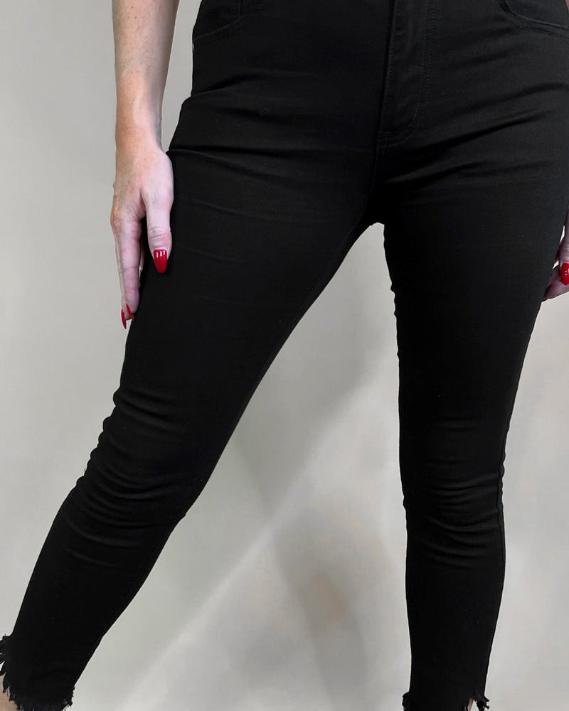 solid black mid-rise jeans with a distressed hem, zip button-up fly, pockets, and some great stretch