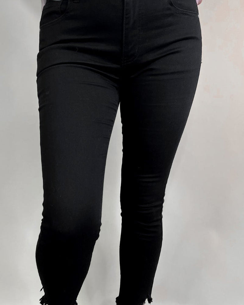 solid black mid-rise jeans with a distressed hem, zip button-up fly, pockets, and some great stretch