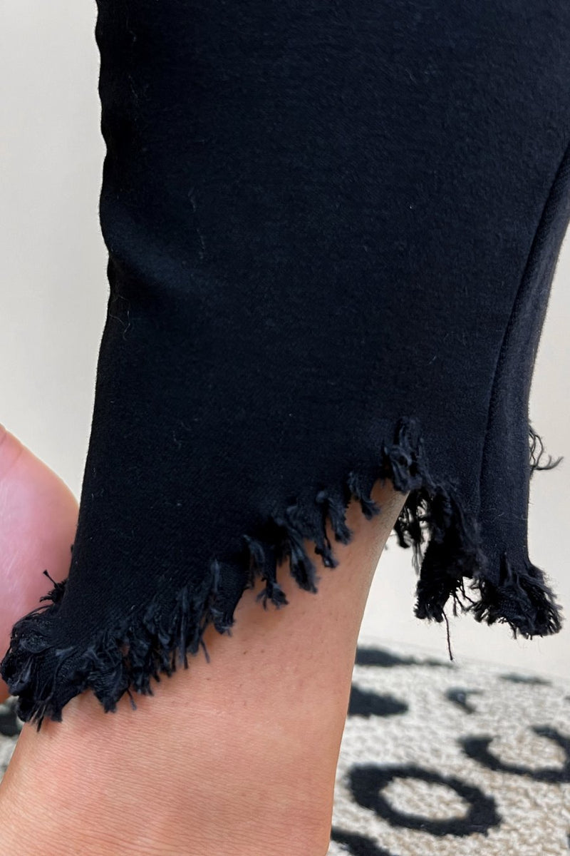 solid black mid-rise jeans with a distressed hem, zip button-up fly, pockets, and some great stretch