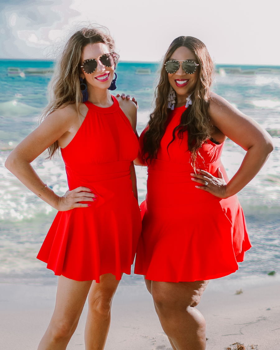 solid red halter swimsuit with a mesh v-neckline leading to a back clasp closure, skirted hem, attached full coverage bottoms, and removable padding