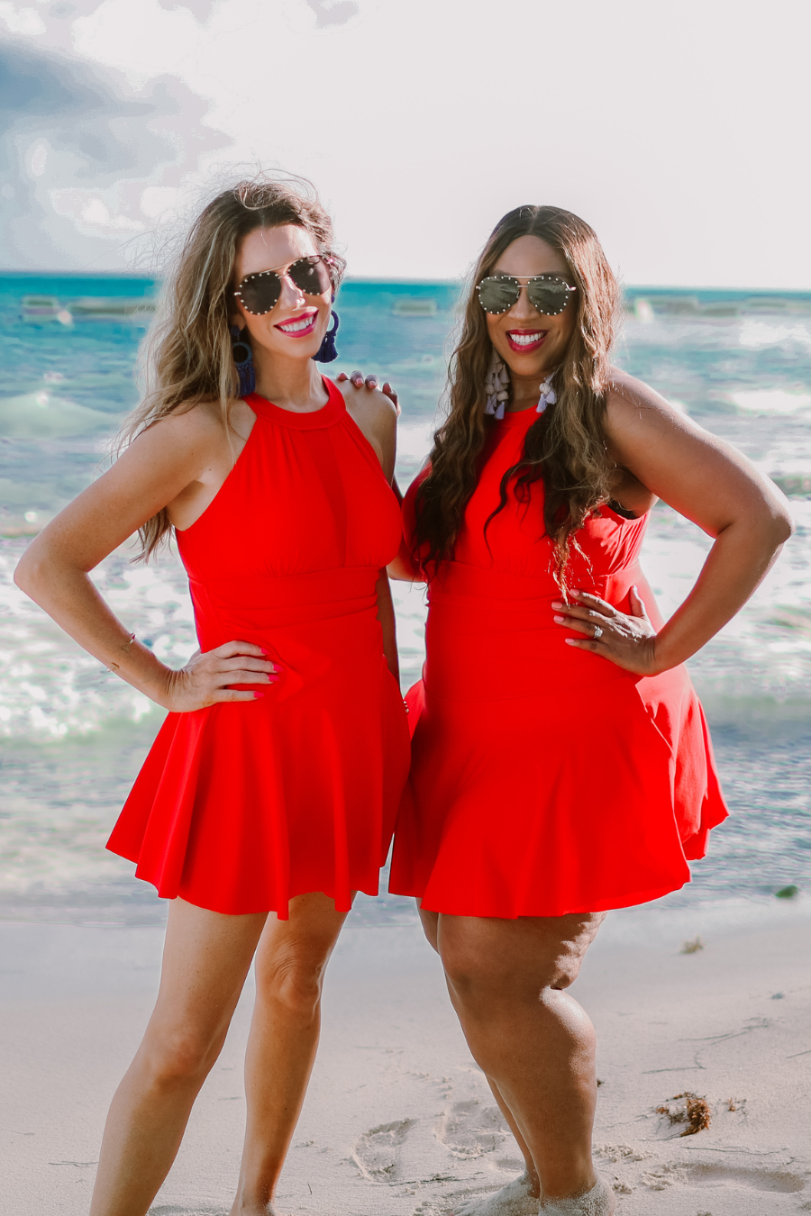 solid red halter swimsuit with a mesh v-neckline leading to a back clasp closure, skirted hem, attached full coverage bottoms, and removable padding