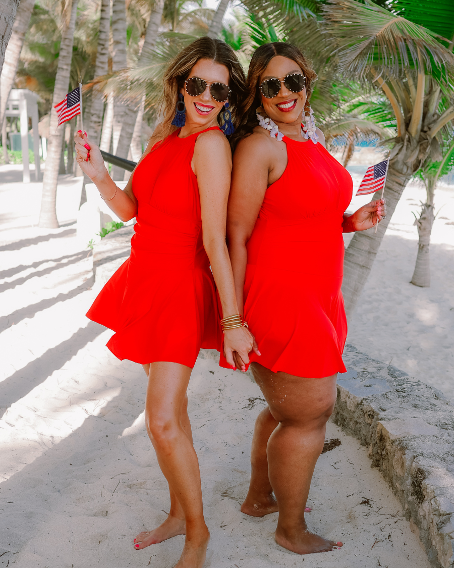 solid red halter swimsuit with a mesh v-neckline leading to a back clasp closure, skirted hem, attached full coverage bottoms, and removable padding