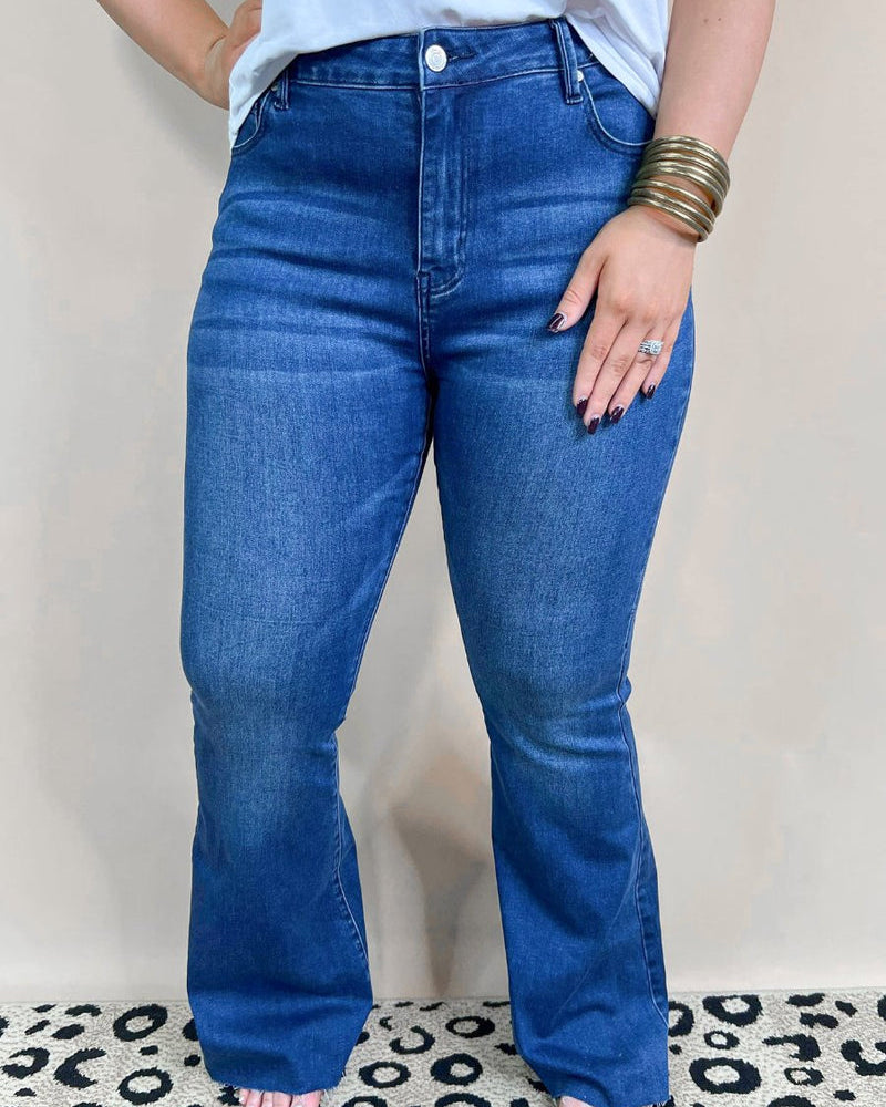 mid-rise dark denim flare skinny jeans with a raw hem, zip button-up fly, pockets, and some great stretch