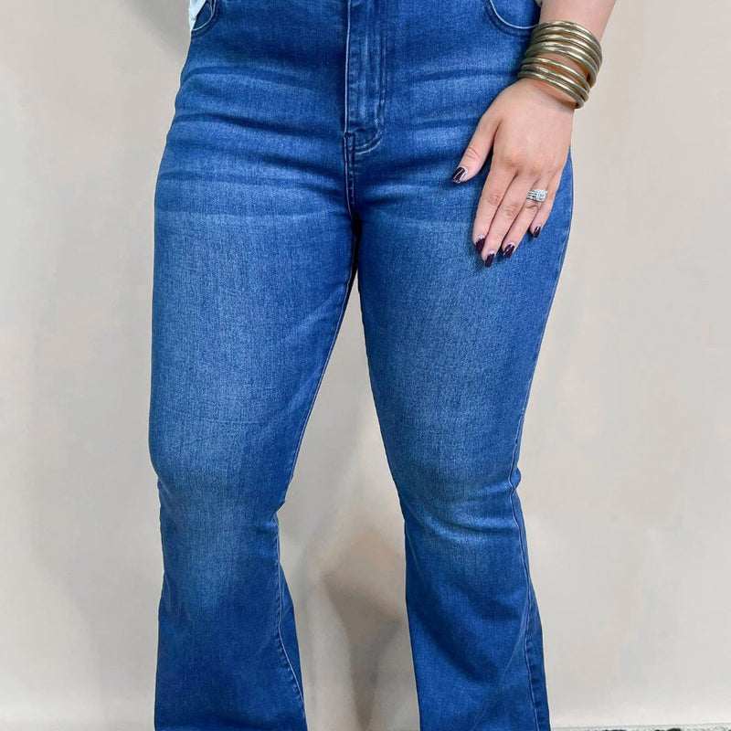 mid-rise dark denim flare skinny jeans with a raw hem, zip button-up fly, pockets, and some great stretch