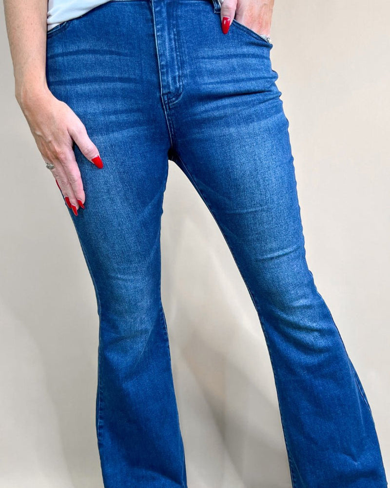 mid-rise dark denim flare skinny jeans with a raw hem, zip button-up fly, pockets, and some great stretch