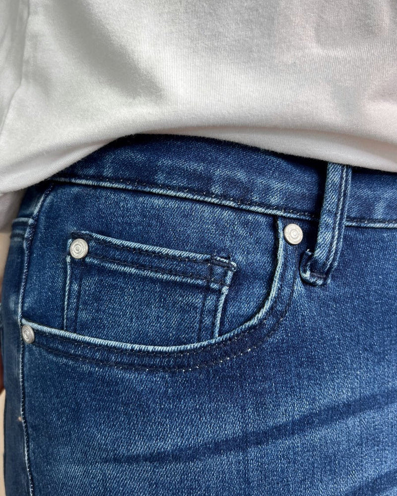 mid-rise dark denim flare skinny jeans with a raw hem, zip button-up fly, pockets, and some great stretch