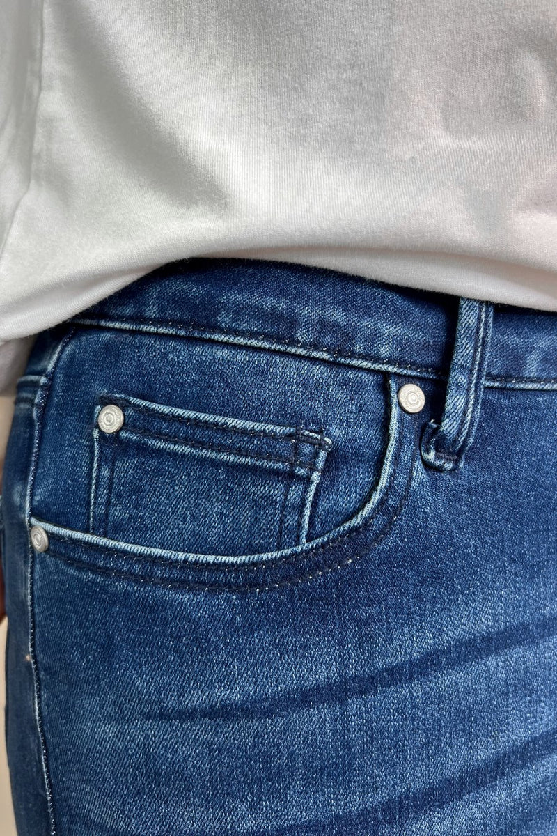 mid-rise dark denim flare skinny jeans with a raw hem, zip button-up fly, pockets, and some great stretch